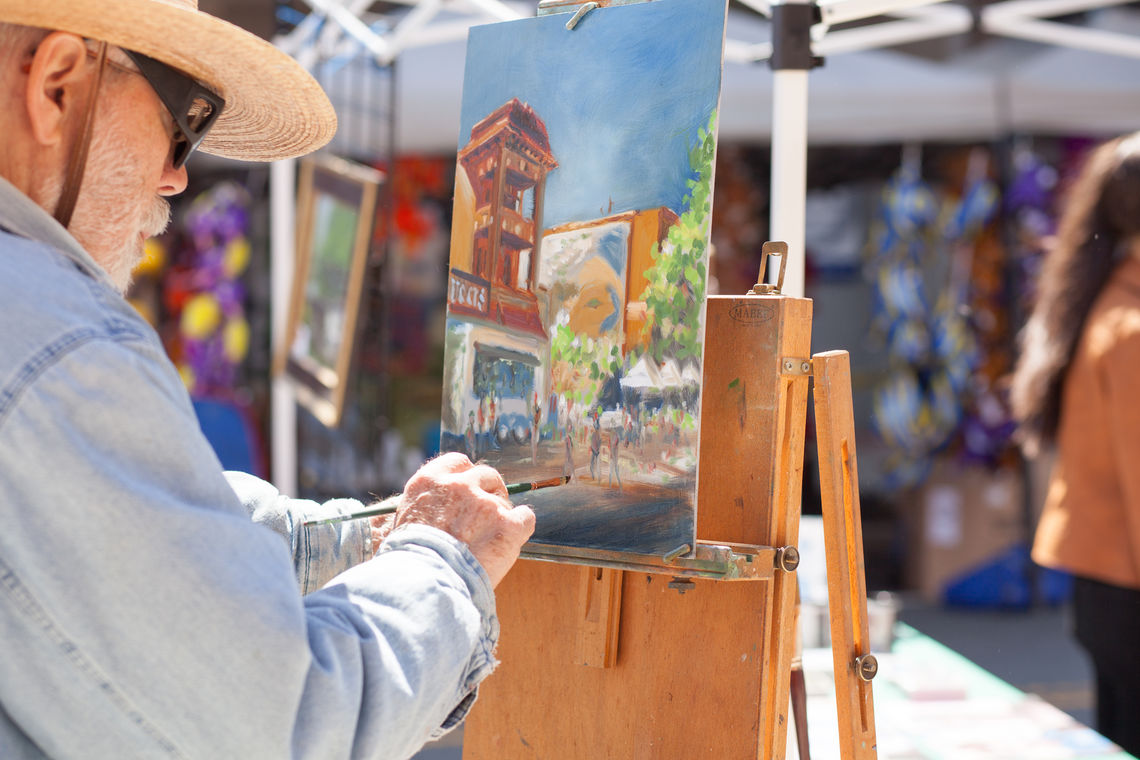 Photo: Portrait artist Harold Grote of the Manayunk-Roxborough Art Center captures a scene during the annual Art Is Life street festival