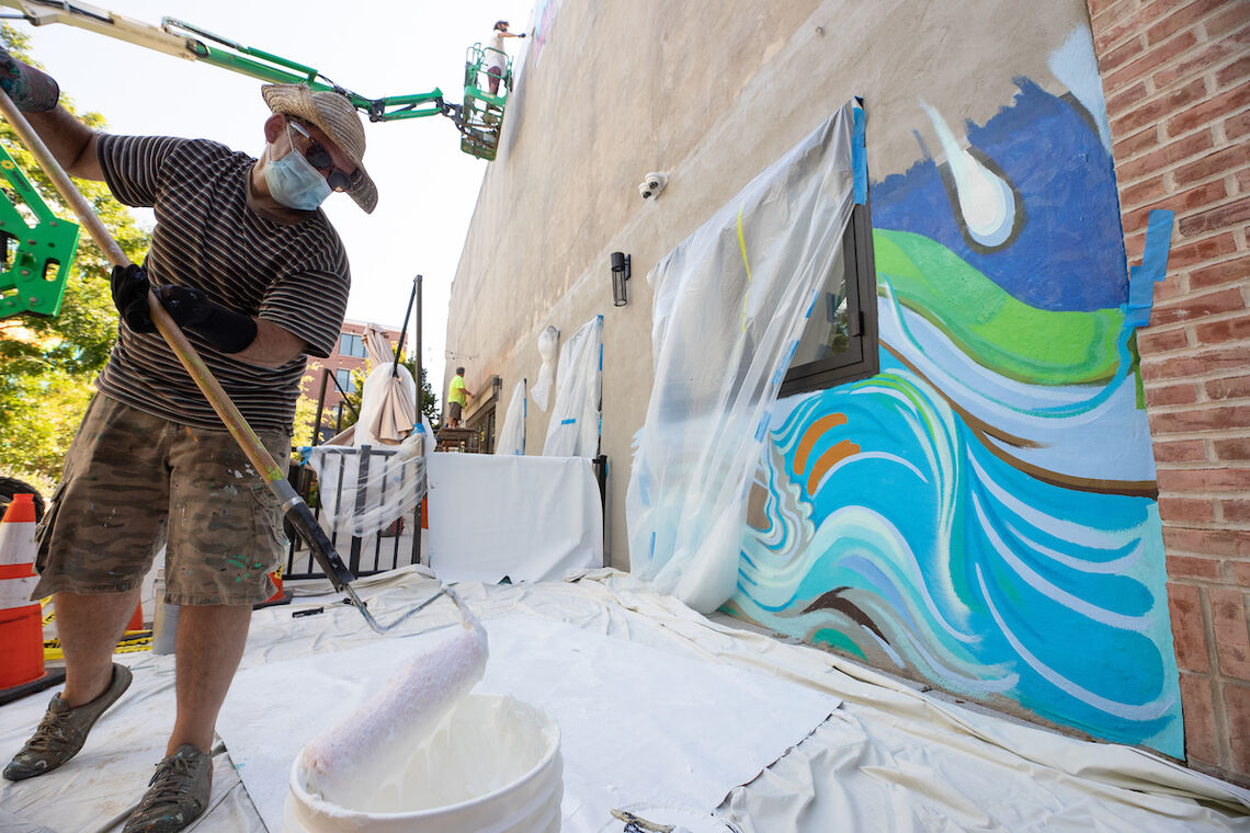 Photo: Artist Paul Santoleri installing the new Pocket Park mural | Steve Weinik