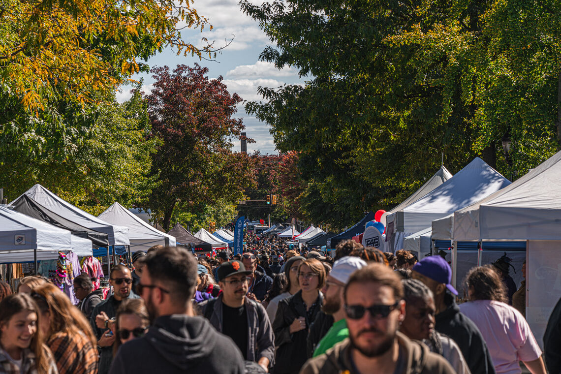 Photo: Attendees of Roxtoberfest walk along Ridge Avenue visiting booths set up along the avenue. Photo Credit | Pel Productions